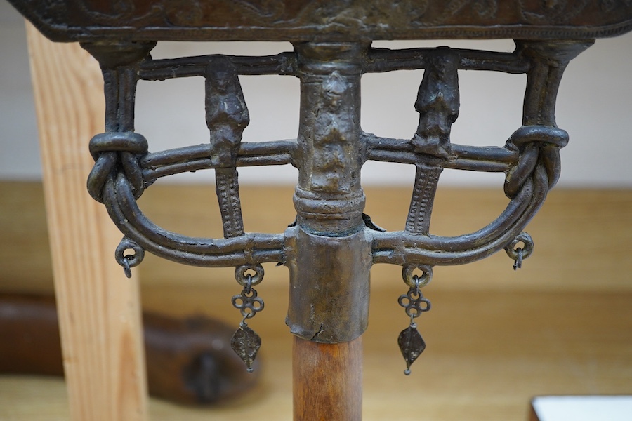 An 18th/19th century Indian Buddhist bronze oil lamp, on a later wood stand, 42.5cm high. Condition - fair